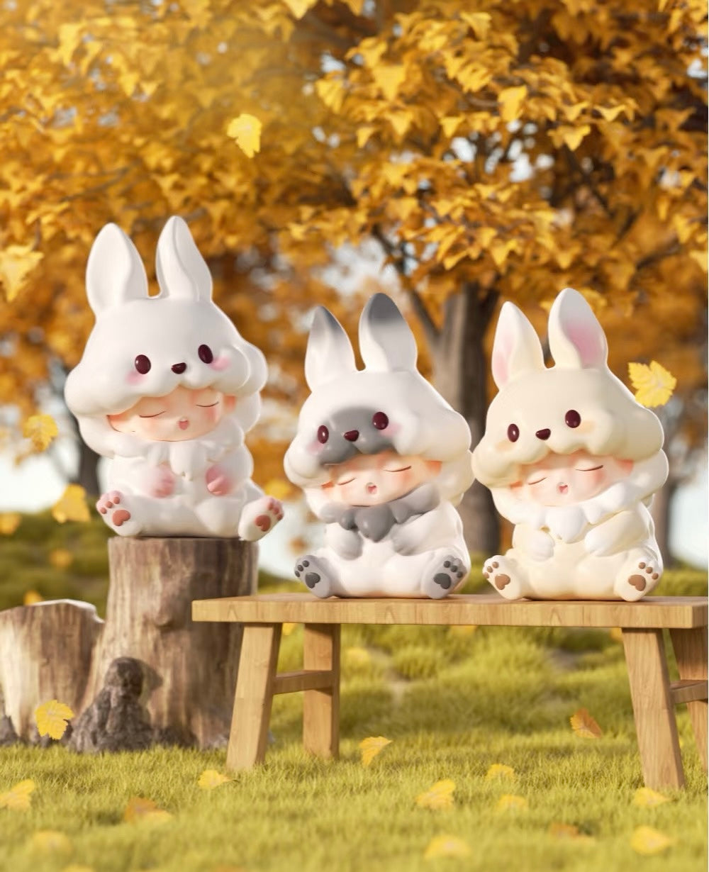 YUMO Stay With You Blind Box Series featuring white bunny figurines on a bench, part of a collectible toy series with secret designs.