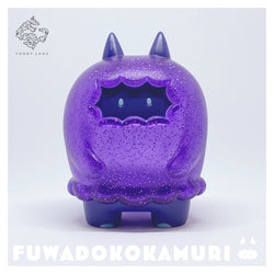 Sofubi toy of Fuwadokokamuri - Magical Amethyst by Moya, a purple cat-like animal figure with a cartoonish blue face.