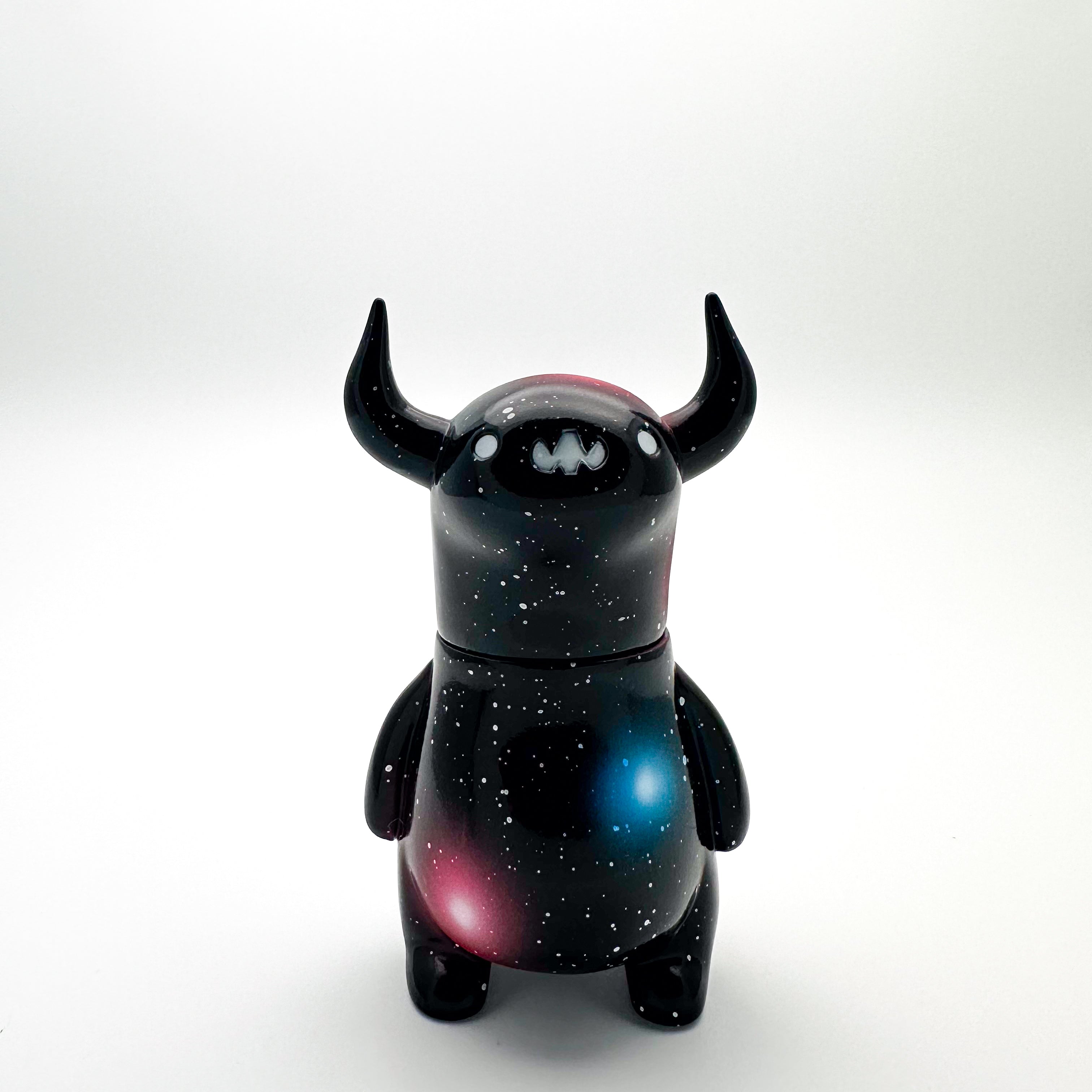 Sofubi toy figurine of a black monster with horns and stars, by Chishima Konosuke.