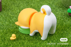 A Shiba Inu GouQi Blind Box Series toy animal on grass, part of Strangecat Toys' blind box collection. Preorder now for June 2024.