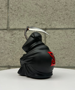 A limited edition resin figure titled Grim Ideas - The Lone Reaper by Riser, depicting a black figure with a scythe and a ninja statue with a sword. Stands 7 tall.
