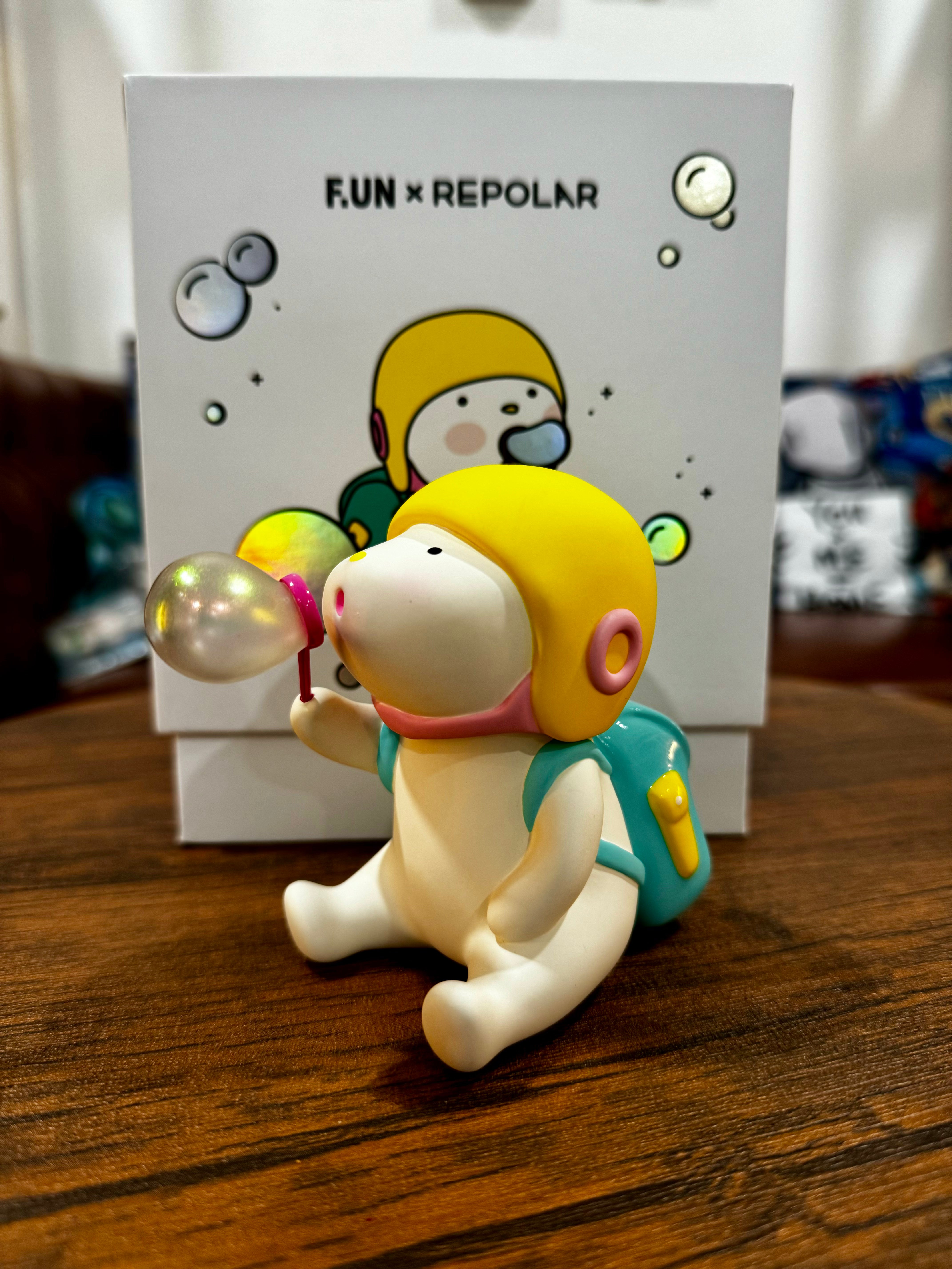 A blind box toy figurine, Repolar 150%, blowing bubbles with a yellow helmet and blue backpack. Limited edition PVC, 6-inch.