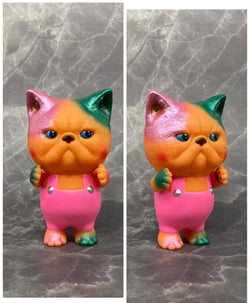 A blind box Sofubi toy: Bird Ark - Exotic Short Hair, a 11.4cm figurine of a toy cat in pink overalls. From Strangecat Toys.