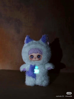 Maymei Dark Forest Plush Blind Box Series featuring a stuffed toy with a purple wig and blue eye, highlighting its plush and cartoonish design.