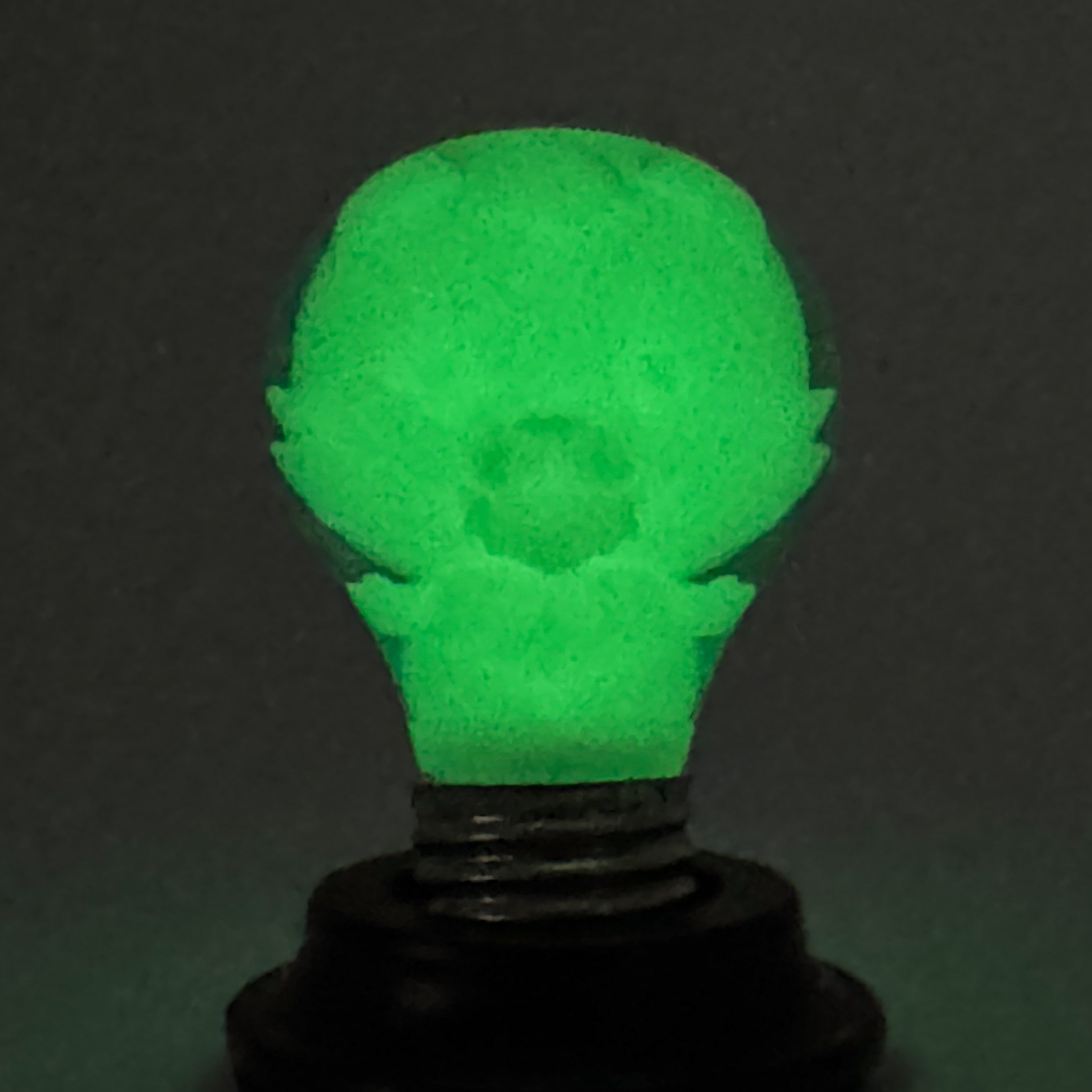 Hello World - GRANDPA GID BLB by JFO, featuring a green light bulb on a black stand, includes micro batteries and is an exclusive Strangecat Toys art piece.