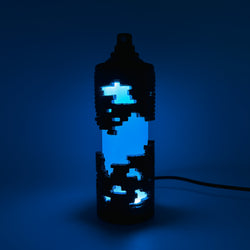 Hello World - BRIX NEBULA CAN by JFO, featuring a blue light within a sleek black container, includes a power cable. Ships 28 days post-show opening.