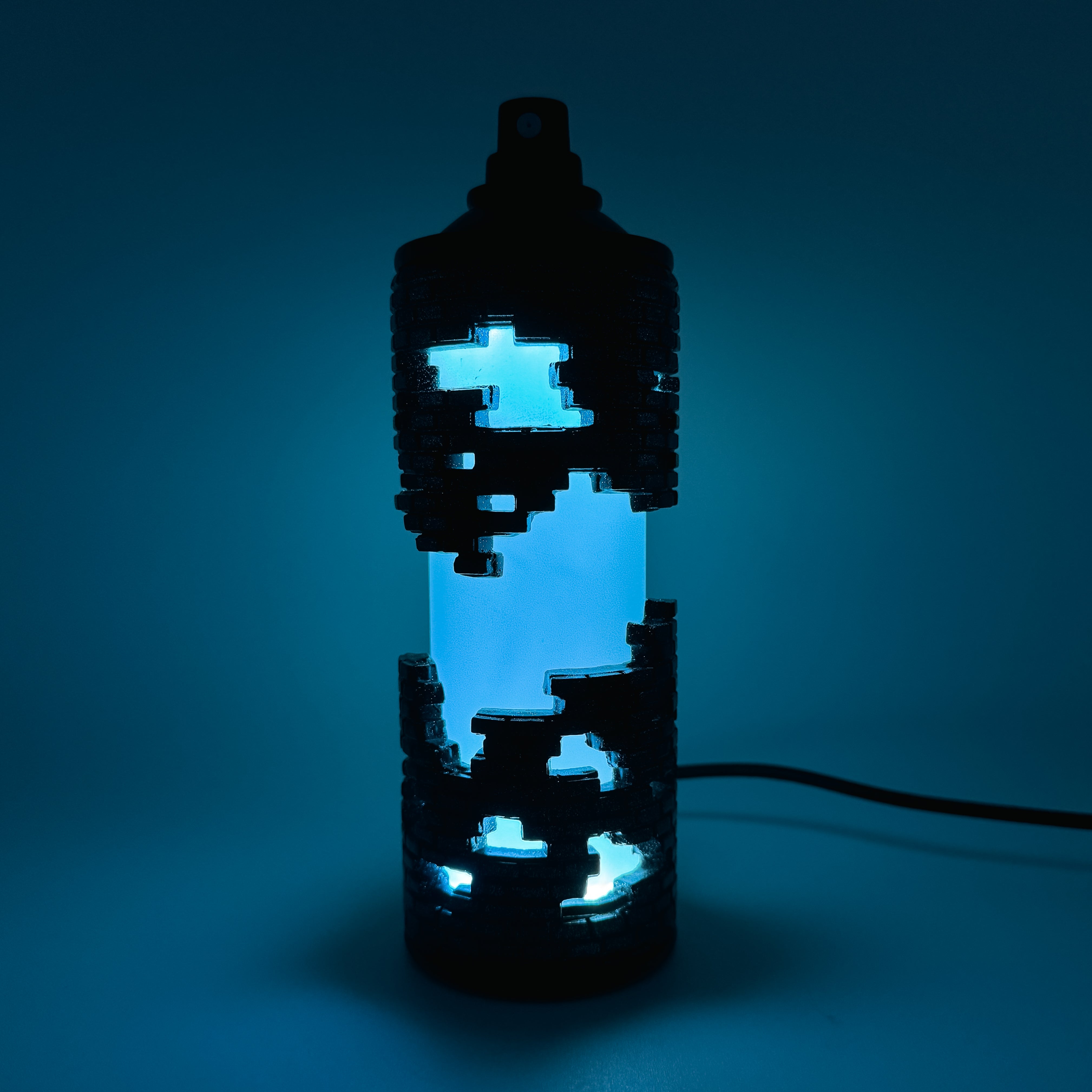 Hello World - BRIX NEBULA CAN by JFO features a blue light inside a bottle, includes a power cable, and ships 28 days post-show opening.