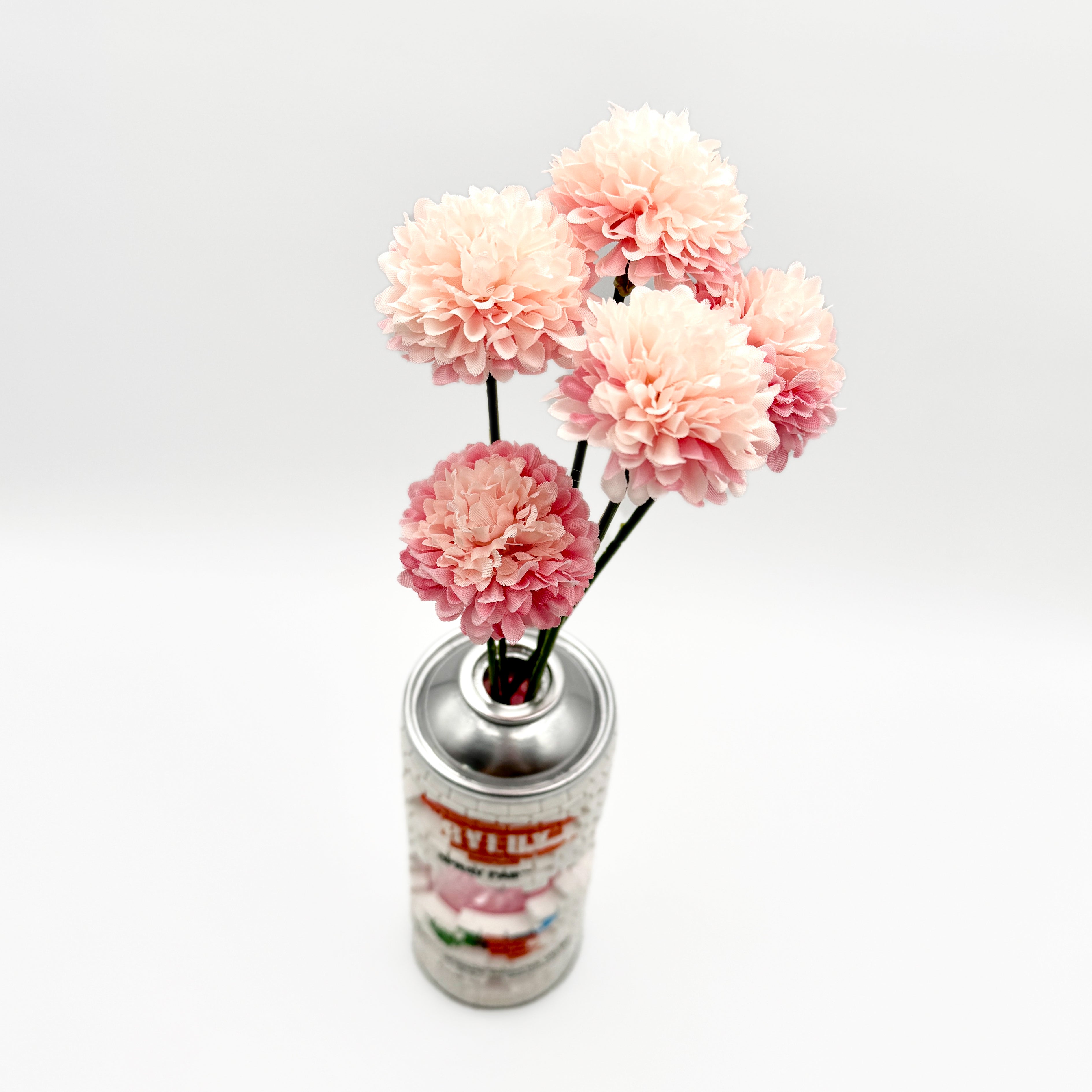 Hello World - BRIX CAN VASE by JFO features pink flowers arranged in a silver can, showcasing a unique floral design.