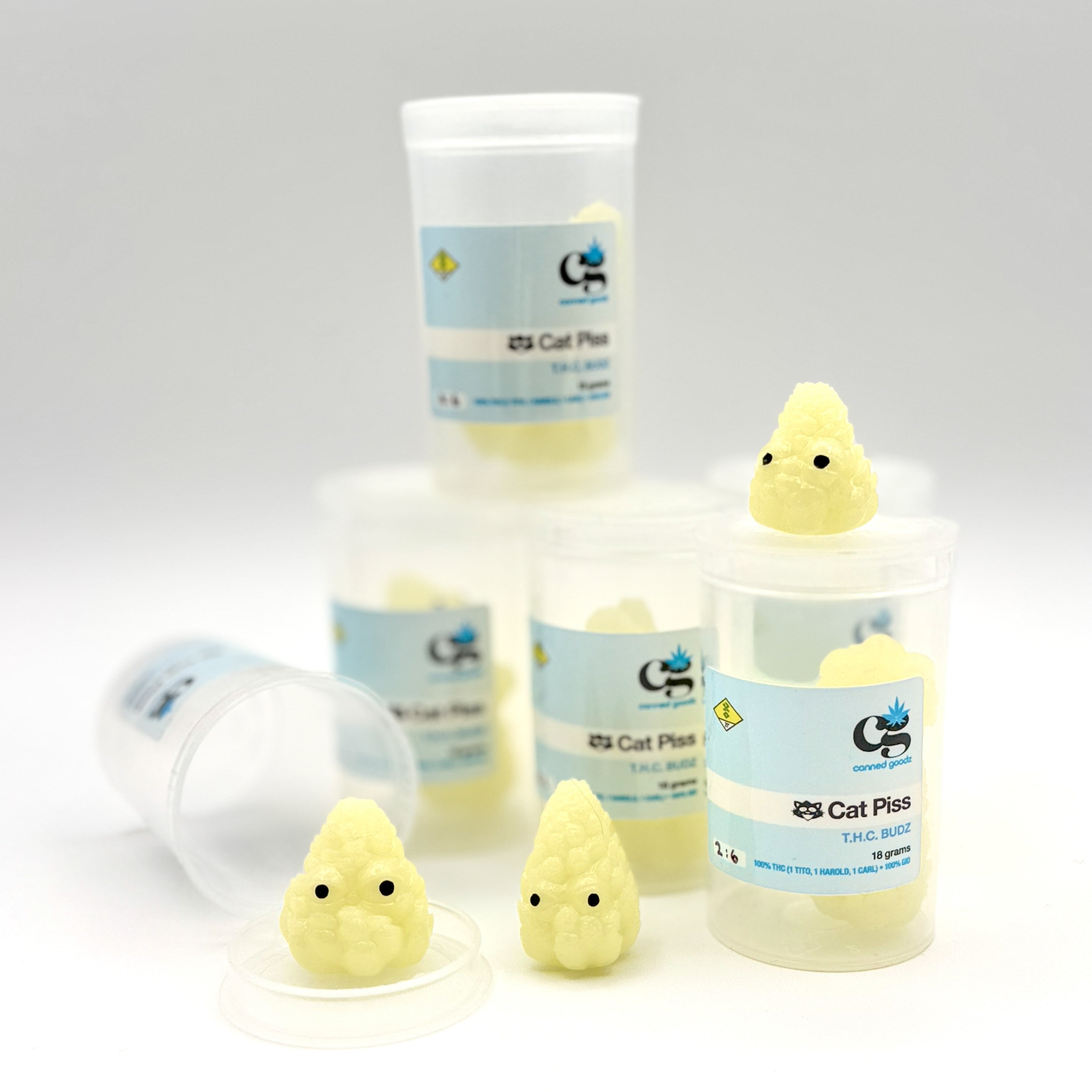 Hello World - THC BUDZ by JFO, featuring plastic containers with yellow toy figures, available in sets of three.