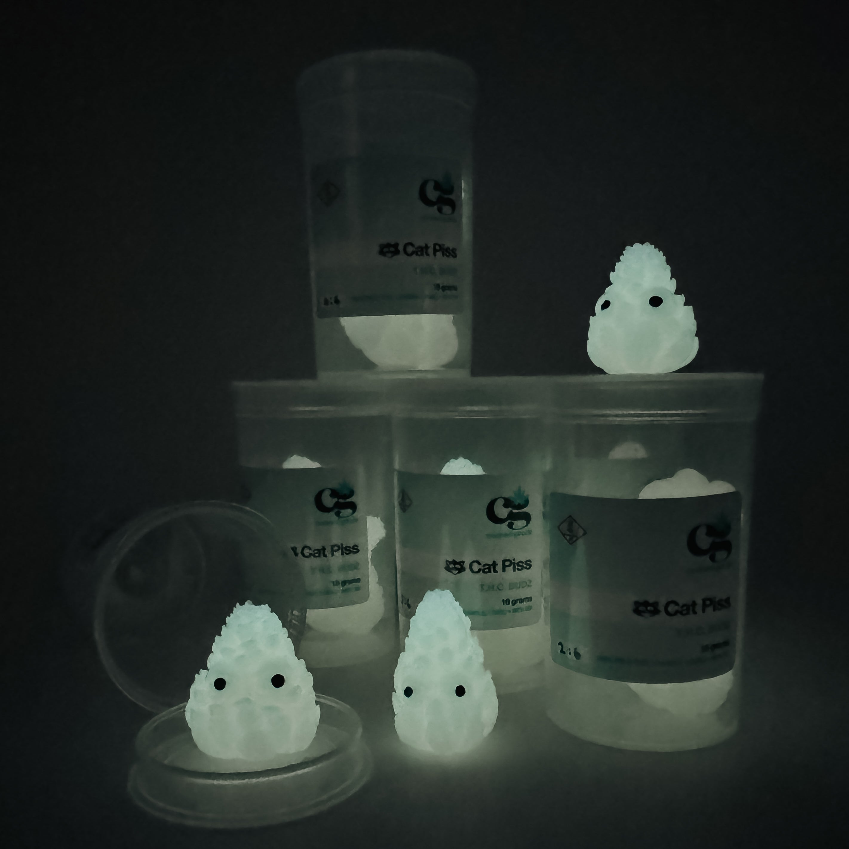 Hello World - THC BUDZ by JFO: Set of three art toy containers with glowing elements, featuring distinctive white figures with black eyes.