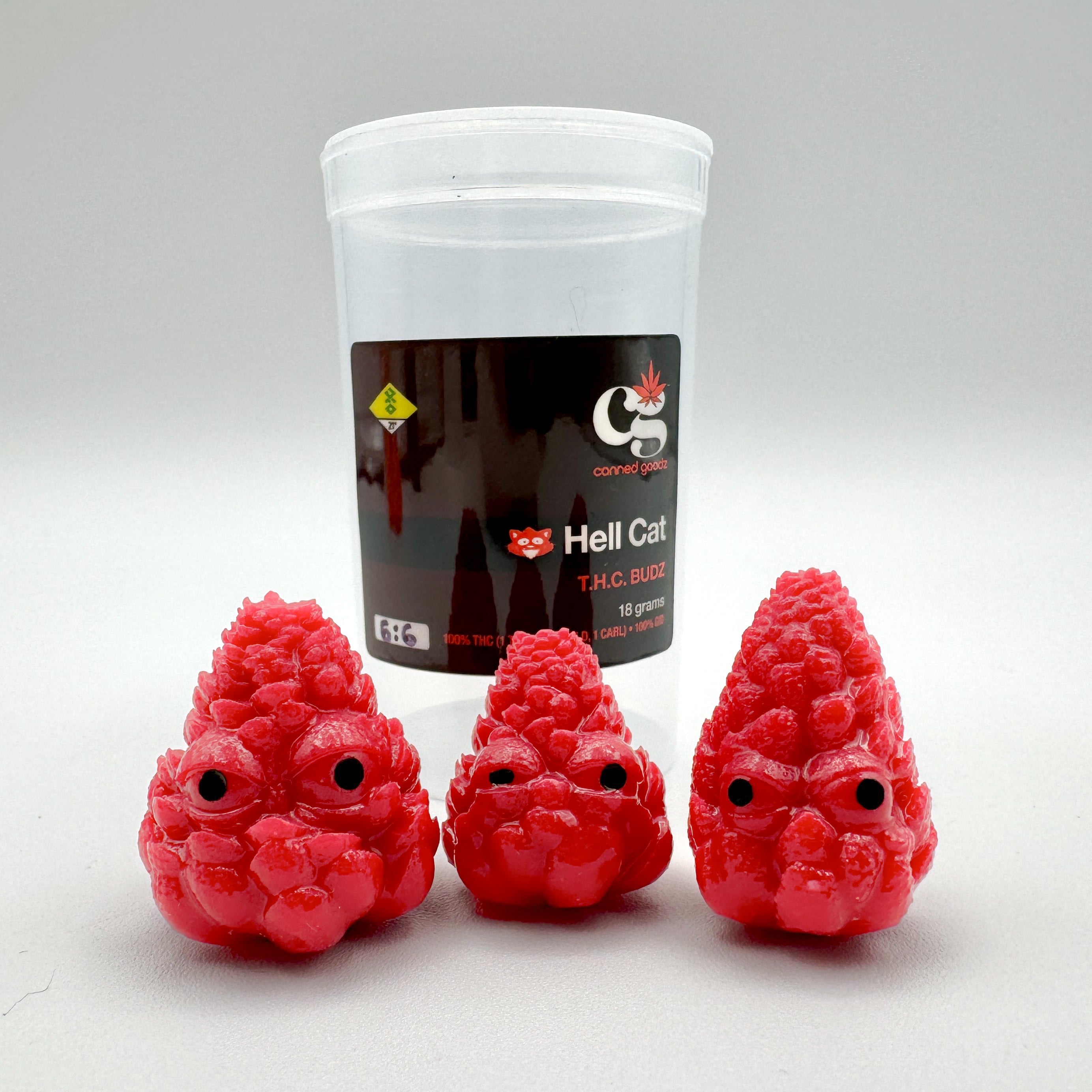 Hello World - THC BUDZ by JFO: A plastic cup with brown liquid and whimsical red characters with black eyes, part of Micro Sets of 3.