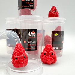 Hello World - THC BUDZ by JFO in plastic containers, featuring red objects with faces, aligned with blind box art toys from Strangecat Toys.