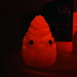 Hello World - THC BUDZ by JFO: Orange candle with black eyes, part of a micro set of 3 art toy pieces from Strangecat Toys.