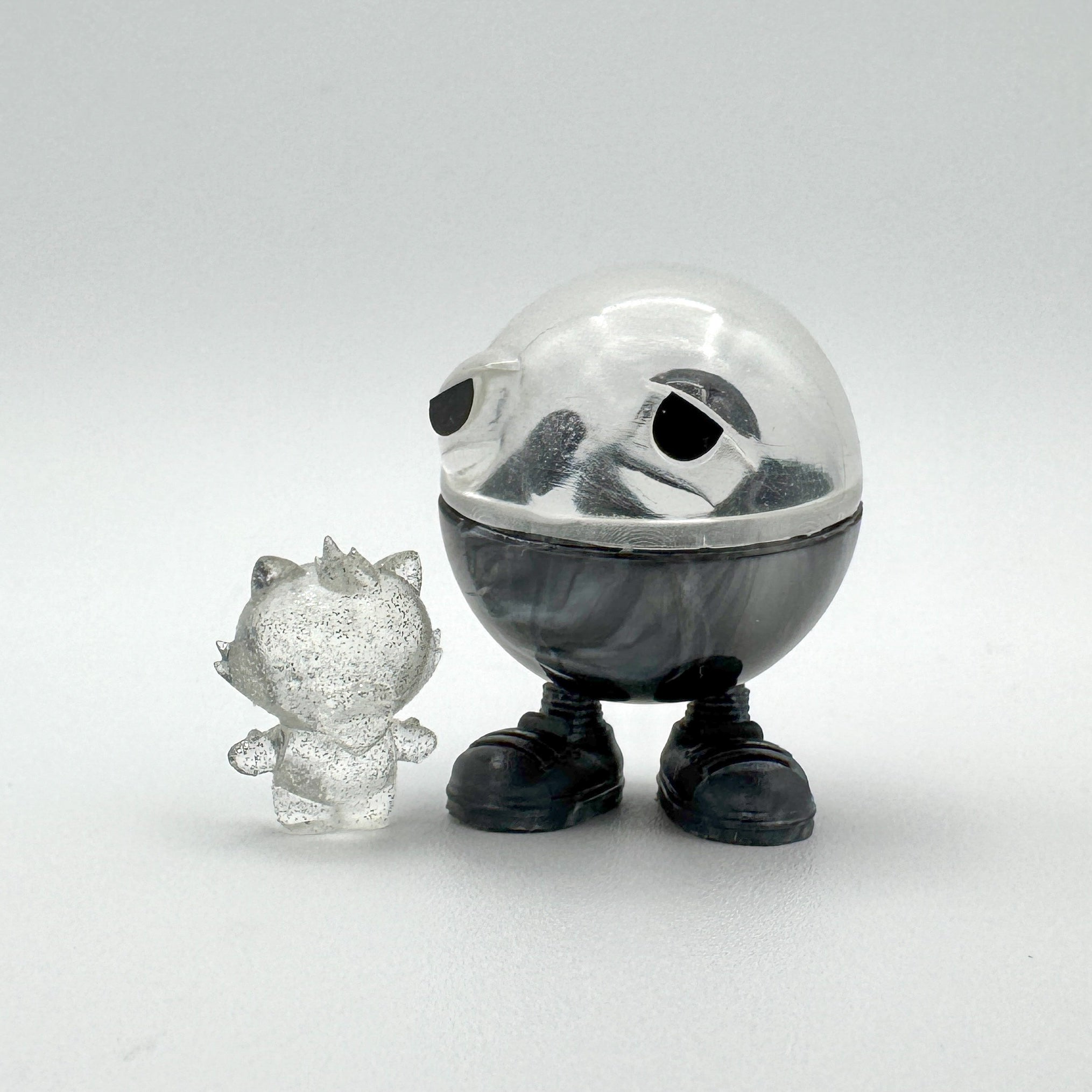 Hello World - MR. CAPS + GRANDPA by JFO, a plastic toy with a clear plastic sphere, includes power cable and base, from Strangecat Toys.