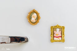 Lulu the Piggy chef and MiMi chef 3D magnet portraits in gold frames with plush animals and chef hats.