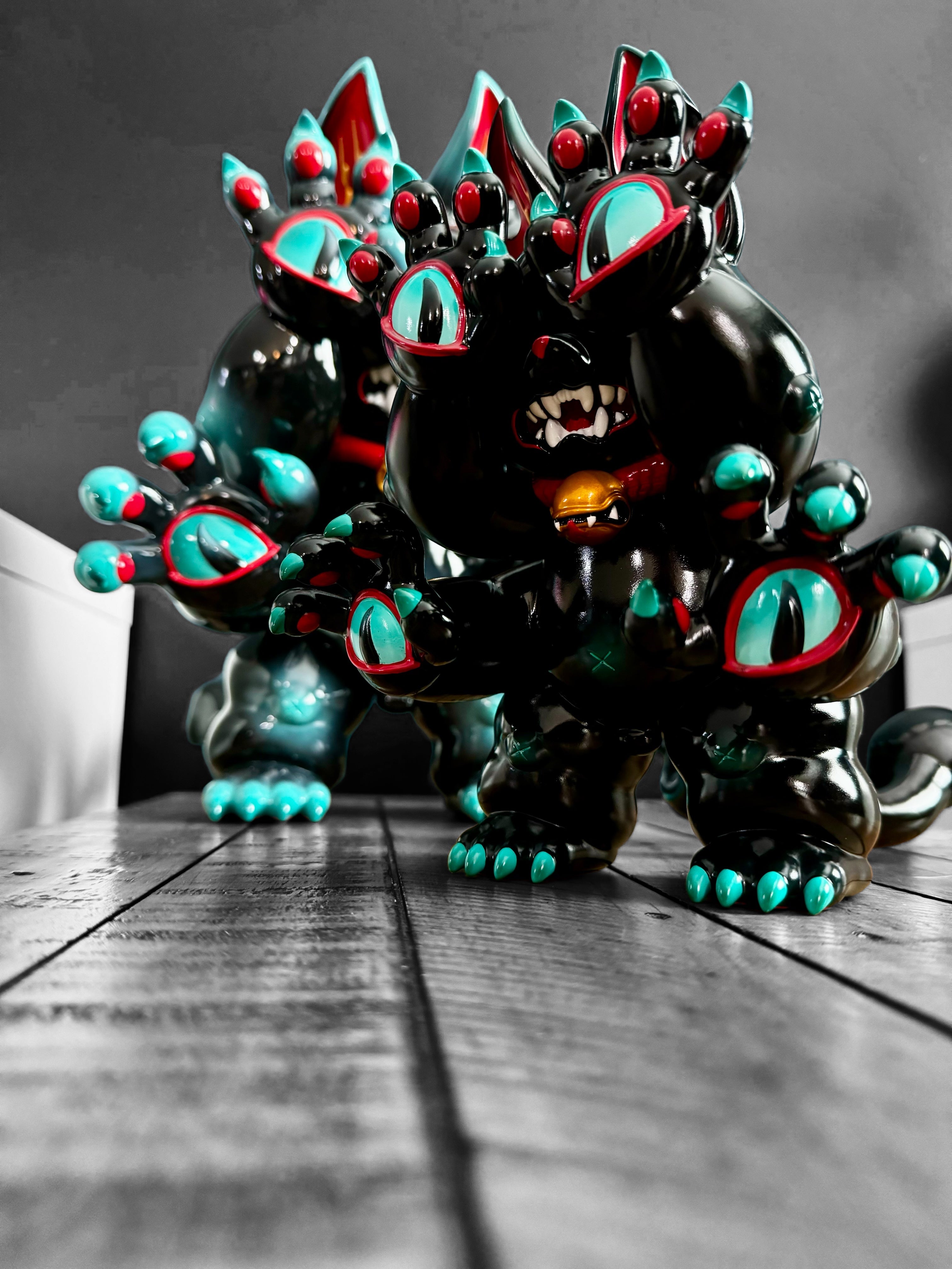 A blind box and art toy store presents DAINIGIRUJIN Black Ver. by Grape Brain. Vinyl toy, 8 tall, 9.5 long, limited to 100pcs. Close-up of black and red toy animal.