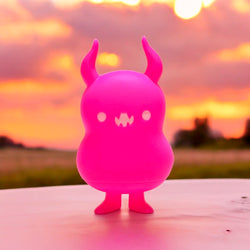 A Japanese Sofubi toy, Babababa Fluorescent Pink by Chishima Konosuke, featuring a pink animal figure with horns and a face. A blind box and art toy store.