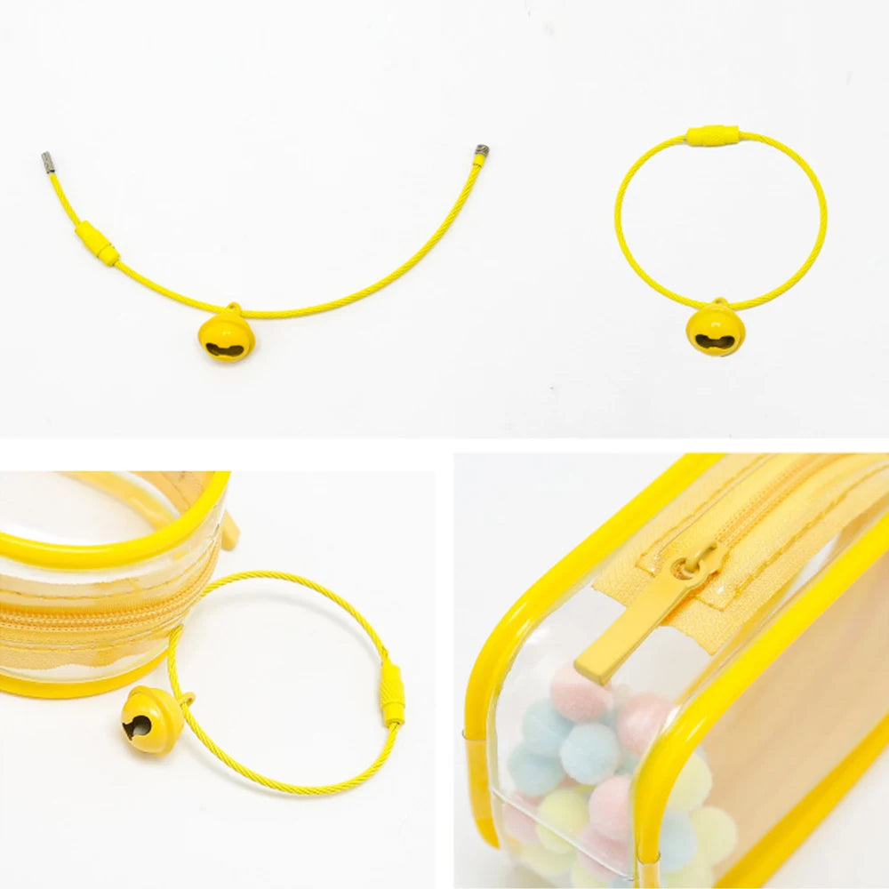 Alt text: Toy Pochette Keychain with smiley face necklace and yellow zipper on a clear plastic bag with colorful balls inside.