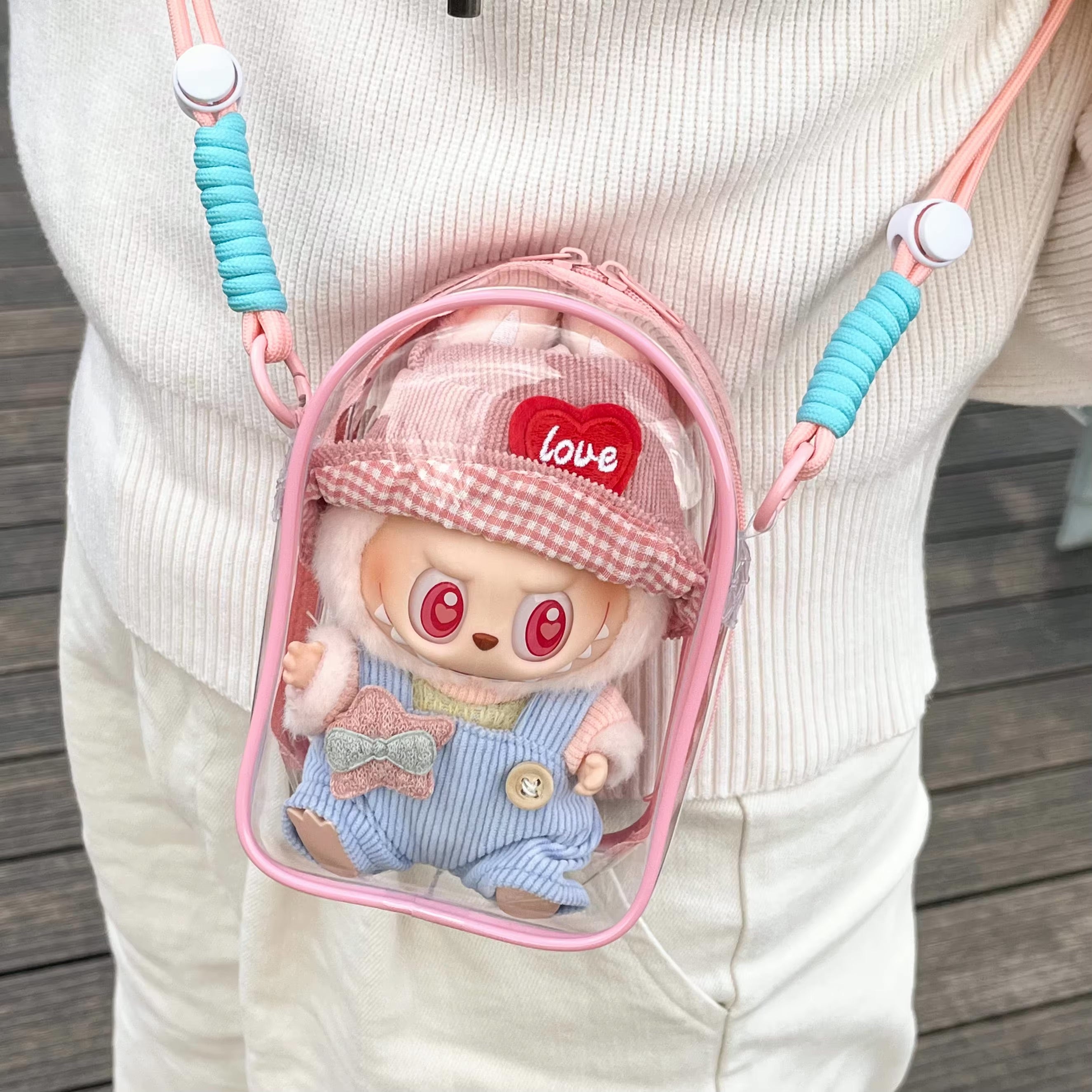 Person carrying a pink Protect Case 15cm Cotton Doll Shoulder Bag with a stuffed animal inside, highlighting its playful and artistic design.