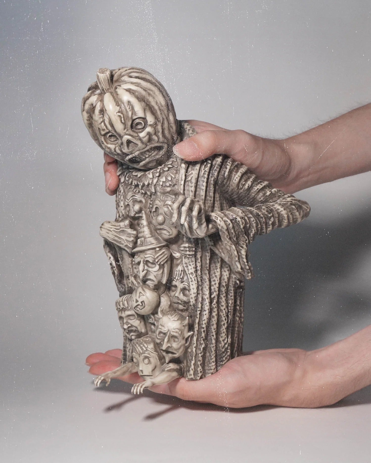 A person holding a statue of The Ghost of Halloween Past 'Bonemarrow Edition' by Sam Heimer.