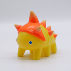 Toy dinosaur with orange spikes and blue eyes, rubber duck, candy corn, and more in Tawashi -Cheerful Yellow by Hanamusic.