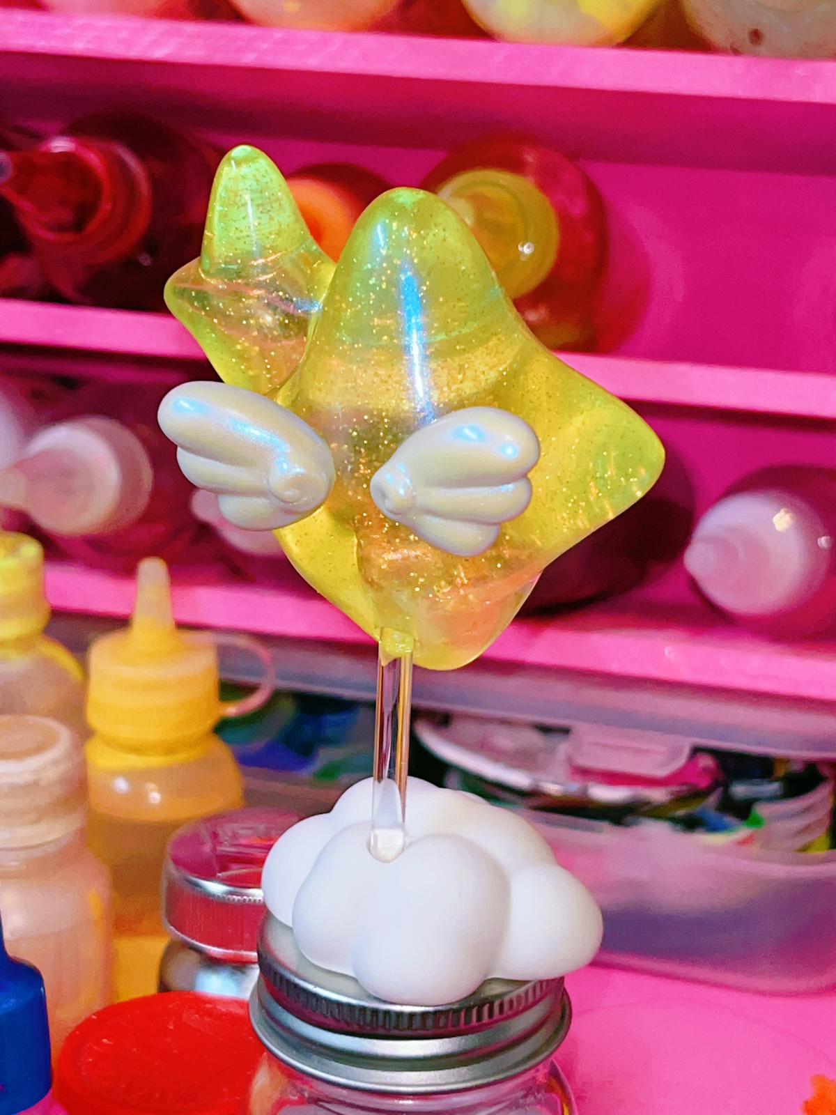 Bling baby Yellow by Kiwi resin toy on a stick with star shape and wings.