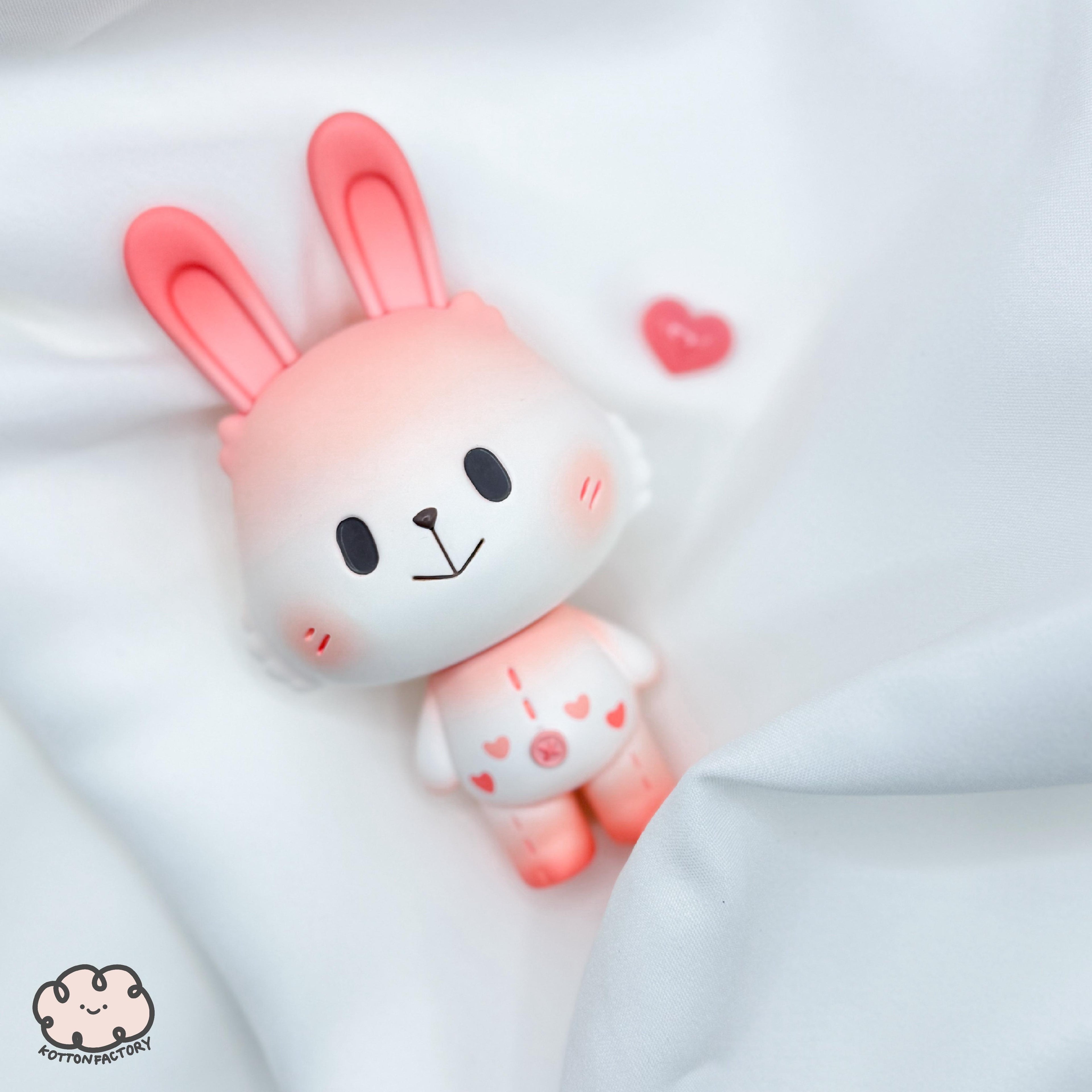 Valentine Robin by Kotton Factory, a plush toy bunny on a white blanket, preorder for Strangecat Toys.