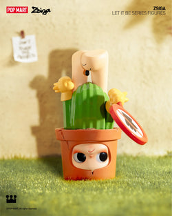 A blind box toy series: Zsiga Let It Be Box - Preorder. Features 12 regular designs and 1 secret. Toy cactus in pot, close-ups of toys. From Strangecat Toys.