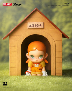 A blind box series featuring Zsiga Let It Be Box - Preorder. Includes 12 regular designs and 1 secret. Toy doll in a dog house setting.