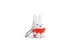 A Miffy Reading Keychain, a toy with a white bunny holding a book, from Strangecat Toys. Certified for ages 3 and up, made of plastic, measuring 1.3x1x2.4 inches.