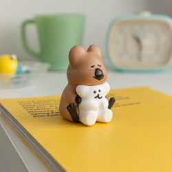 Mini figure of Dinotaeng - Warm Hug with Quokka and Bobo, toy bear hugging white bear and cat, clock, and close-up details.