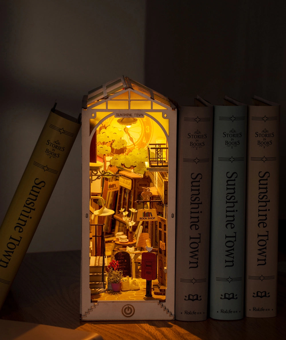 Book Nook Kits For Adults - Sunshine Town: A miniature bookshelf with a light inside, resembling a cozy Tokyo street scene in spring. Dimensions: 9.1 x 12.2 x 1.8 in.