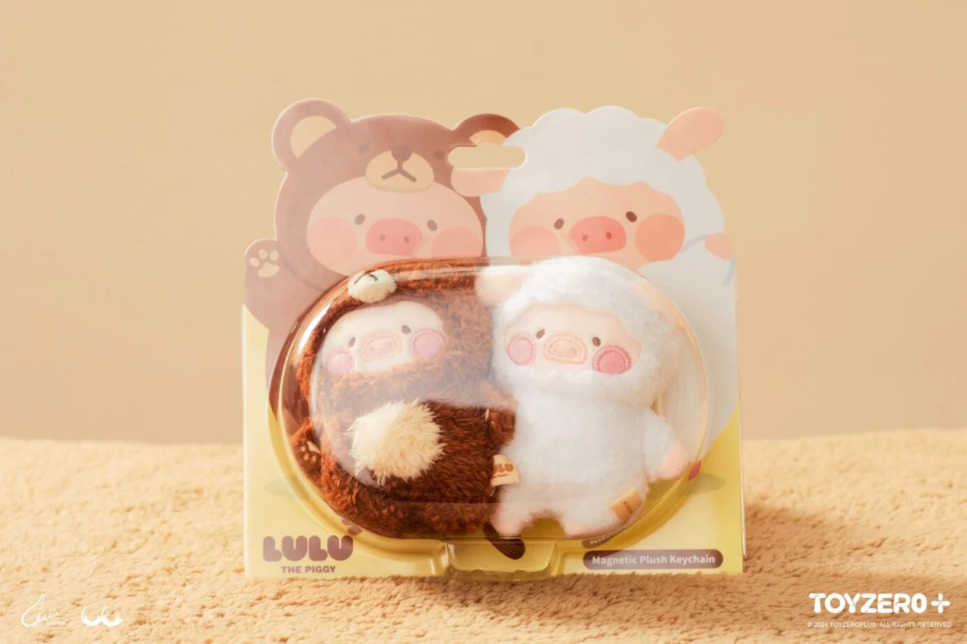 A blind box and art toy store presents: LULU THE PIGGY COSTUME SERIES - MAGNET PLUSH KEYCHAIN SET. Two magnet plush keychains, 8 cm x 4 cm x 10 cm, featuring cuddly Bear LuLu and Sheep LuLu.