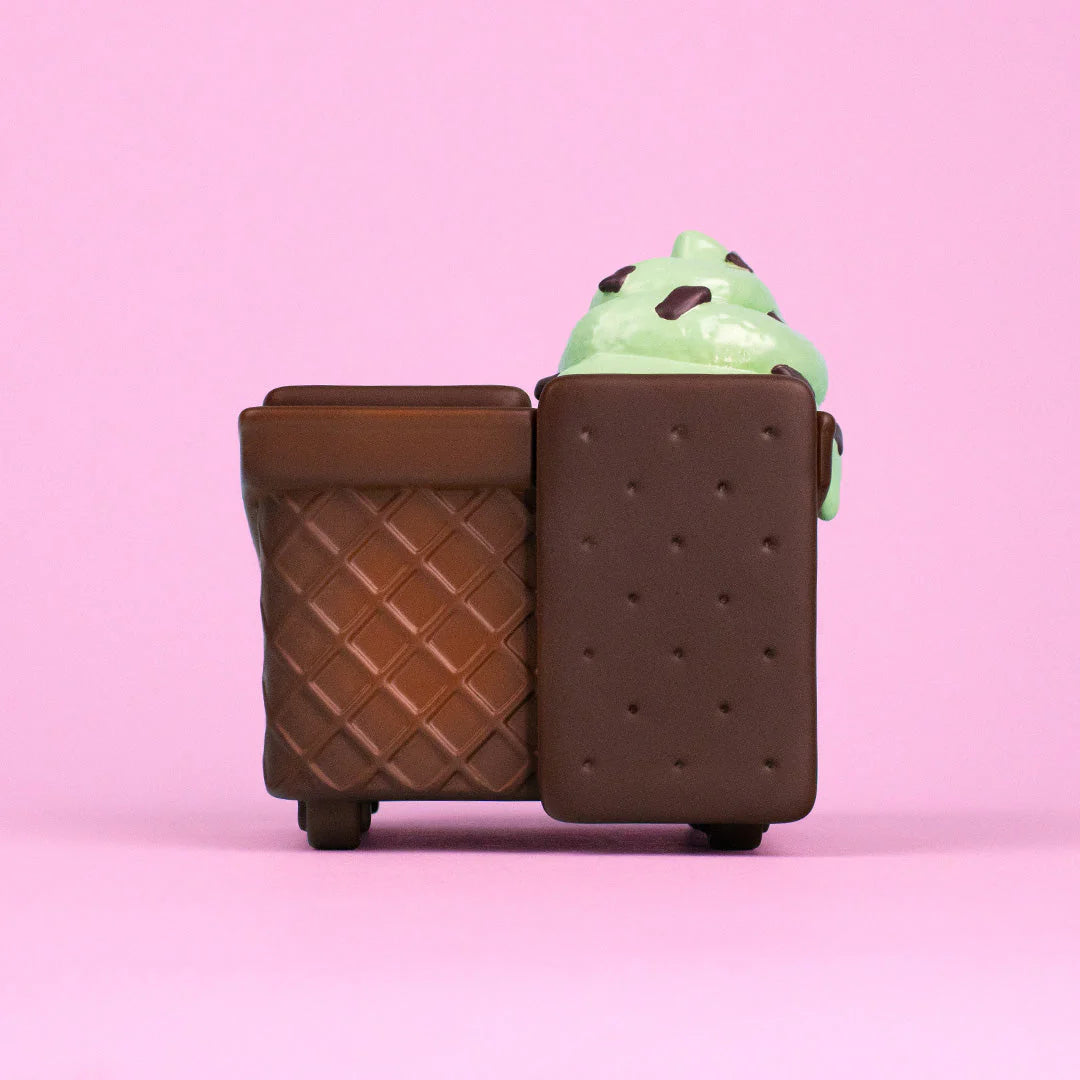 Mint Chip Dumpster Ice Cream Vinyl Figure on a toy cart, featuring a waffle cone body and chocolate biscuit lids, available for preorder at Strangecat Toys.