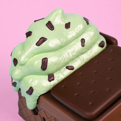 Mint Chip Dumpster Ice Cream Vinyl Figure features a chocolate waffle cone body with melted mint chip details, designed as a unique art toy collectible.