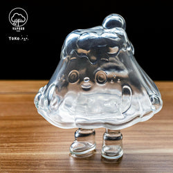 A clear plastic figure of Fuji San Clear by Yoko on a wood surface, soft vinyl, 10cm.