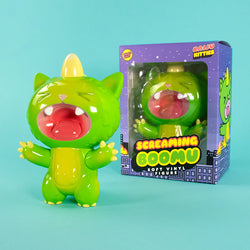 New Screaming Boomu Kaiju Kitty Soft Vinyl Figure with open-mouthed roar, glossy finish, and cute claws, displayed next to its packaging.