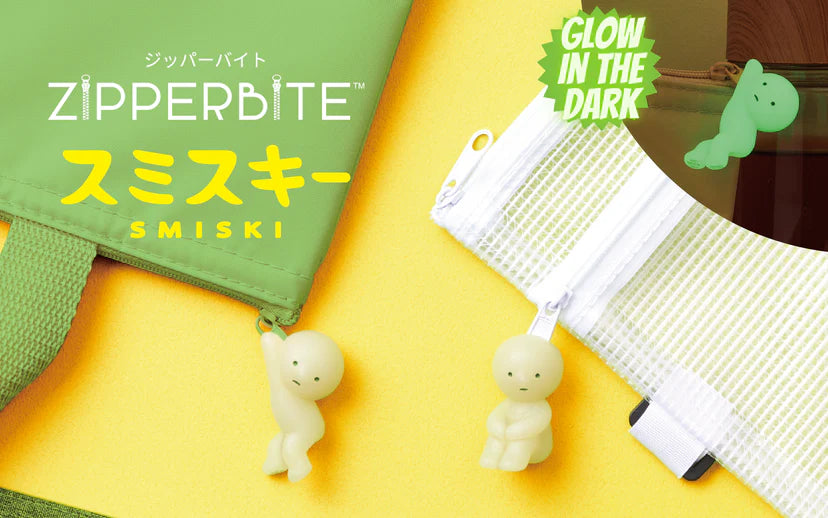 Smiski ZipperBites keychain: a small, glowing figurine with green eyes, attached to a zippered bag, designed to protect keys in your pocket or bag.