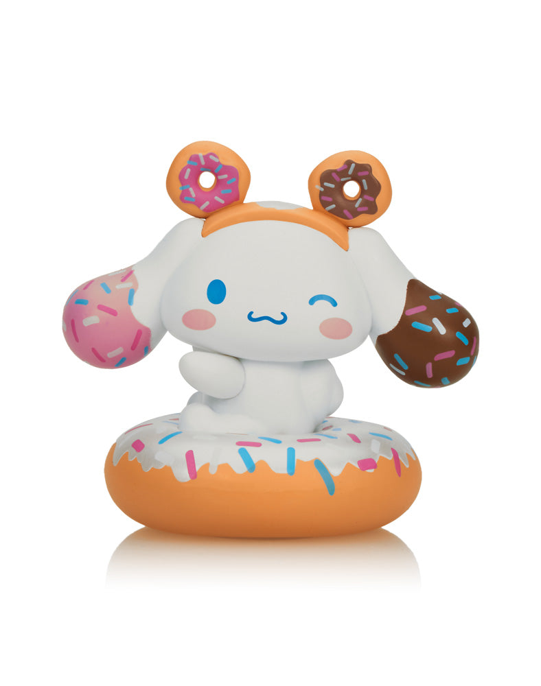 tokidoki X Cinnamoroll Sweet Treats Blind Box featuring a plush toy animal adorned with donut-themed accessories, part of a winter-themed collection.