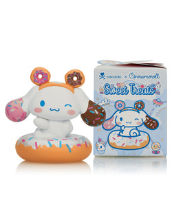 tokidoki X Cinnamoroll Sweet Treats Blind Box toy featuring a cartoon animal with a donut in its mouth next to a themed box.