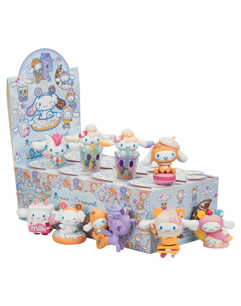 tokidoki X Cinnamoroll Sweet Treats Blind Box featuring various toy characters, including Hello Kitty and friends, in a playful winter-themed setting.