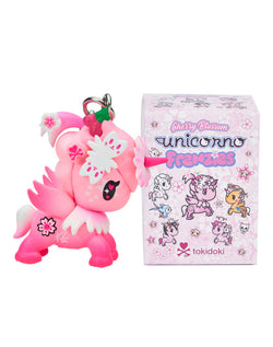 Cherry Blossom Unicorno Frenzies Blind Box featuring a pink unicorn keychain beside a decorative box with cartoon unicorns.