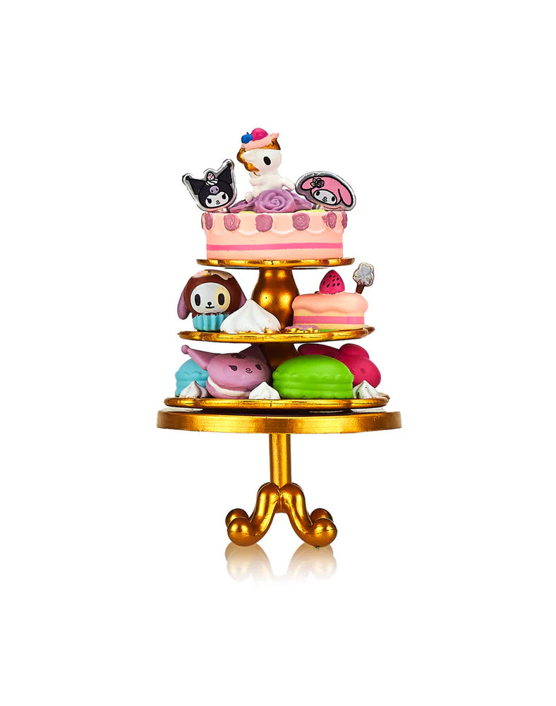 Tokidoki x Kuromi & My Melody Garden Party - Special Edition 2-pack featuring detailed cake stand with cartoon characters at a tea party.