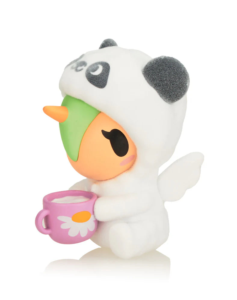 Cozy Unicorno Blind Box collectible featuring a stuffed toy in a panda outfit holding a cup, showcasing unique cozy self-care themed designs.