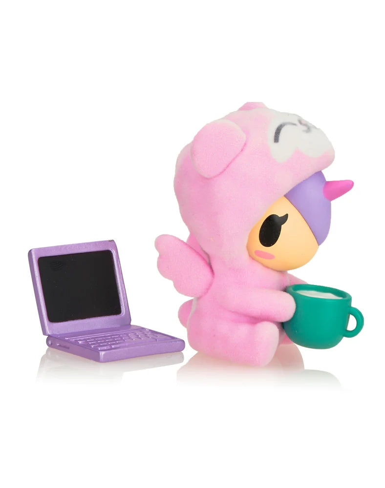 Cozy Unicorno - Cozy Bear (Special Edition) holding a green mug and metallic laptop, showcasing its flocked suit in a collectible art format.