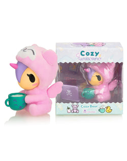 Cozy Unicorno - Cozy Bear (Special Edition) plush, holding a cup, in an open-box collectible format with flocked suit and metallic accessory.