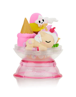 Dreaming Unicorno Blind Box featuring a pink and white toy inside a plastic dome, part of a magical dreamland series from Strangecat Toys.