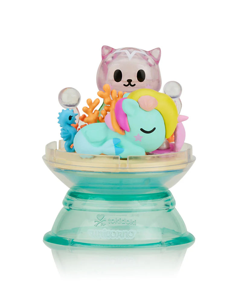 Dreaming Unicorno Blind Box featuring nine collectible unicorn figurines displayed on a stand, each inside a detachable dome, perfect for magical dreamland adventures.