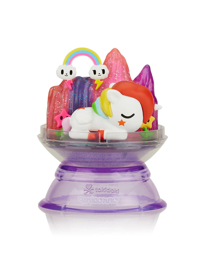 Dreaming Unicorno Blind Box featuring a toy unicorn with rainbow hair on a purple container, packaged in a display dome.