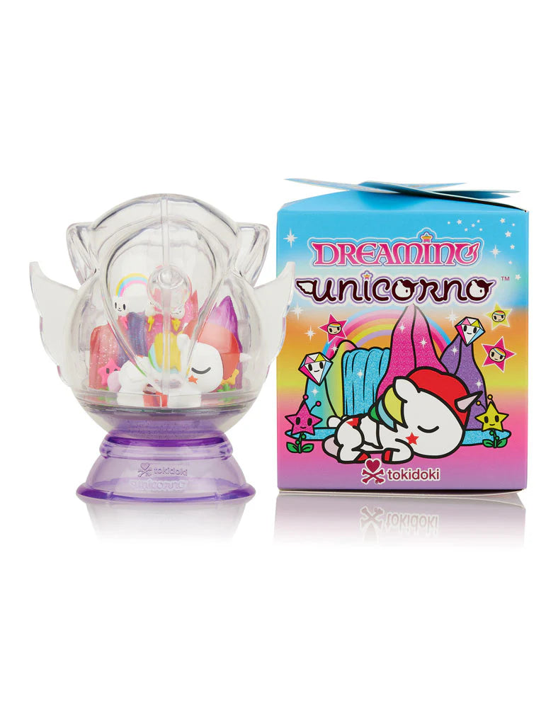 Dreaming Unicorno Blind Box featuring a plastic toy unicorn in a clear dome, packaged in a box with a cartoon unicorn sleeping on a rainbow.